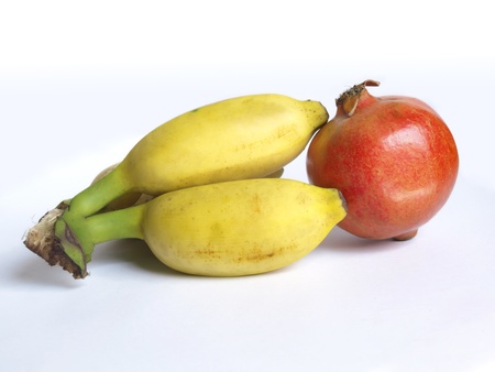 Ripe pomegranate fruit and bananaの写真素材