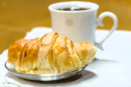  A croissant with coffee cupの写真素材