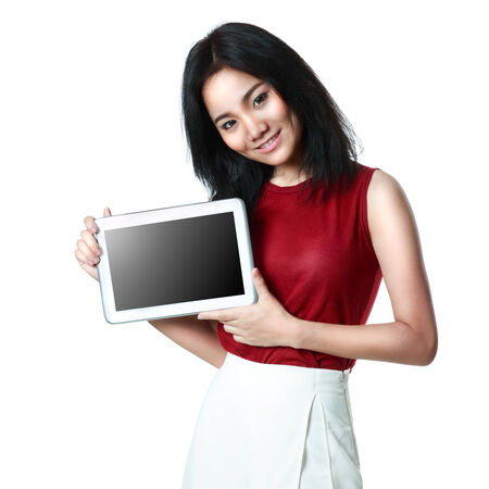Young asian girl holding a tablet computer, Isolated over whiteの写真素材