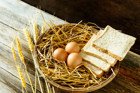Eggs and bread in the basket with still lifeの写真素材