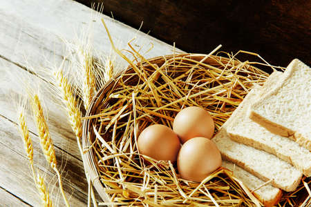 Eggs and bread in the basket with still lifeの写真素材