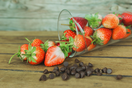 lass of red strawberry and chocolate. Strawberries on wood backgroundの写真素材