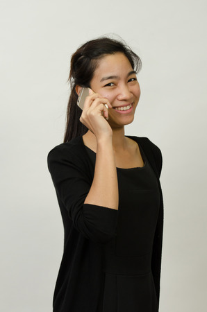 happy confident businesswoman talking on the mobile cell phone isolated on white.の写真素材