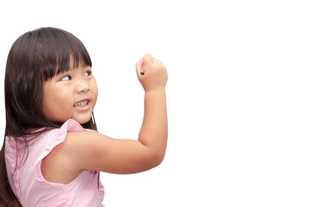Asian child girl holding crayon write board,on the white background.の写真素材