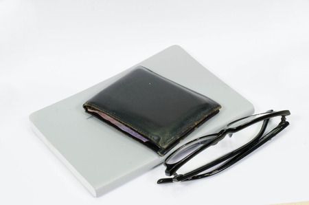 Picture of black glasses on a white book.の写真素材