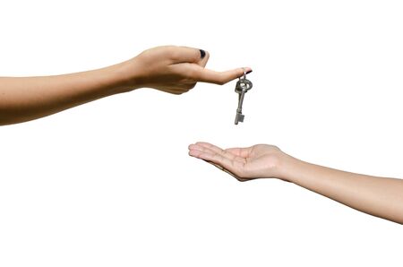 Human hand holding house keyの写真素材