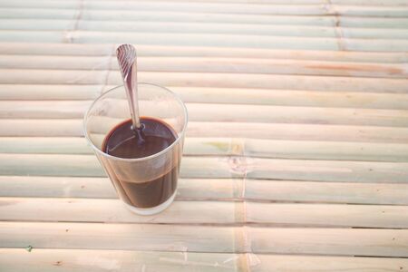 Thai local hot coffee on wooden tableの写真素材