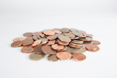 Heap of coins isolated on white backgroundの写真素材