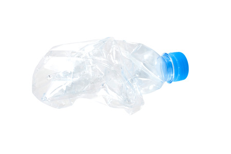 Mineral water bottle crushed and crumpled against white isolated backgroundの写真素材