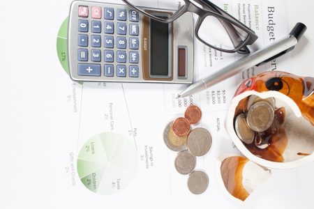 piggy bank and calculator on business documents background.の写真素材
