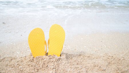 Beach vacation concept- slippers and sunglasses at sea.の写真素材