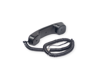 Black handset from landline phone on a white background.の写真素材