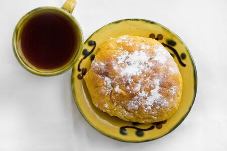 Cup of tea and sweet buns on the saucerの写真素材