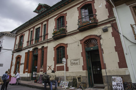 Bogota Colombia October January 2013 Typical street of touristy district La Candelaria with people walking along sidewalks This photo depicts daily life of bogotans inhabitants of Bogota and typical arrangement of houses onetwo storeysのeditorial素材