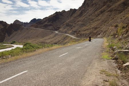 Man on the bicycles in Iran. Aras river and mountain. Border with Azerbijanの写真素材