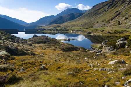 Pyrenees mountain view. Smal mountain lake, in background dam. Summer day. Andoraの写真素材