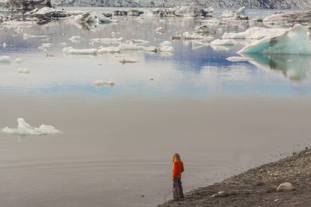Child on coast of Jokulsarlon glacier lagoon  Iceland の写真素材