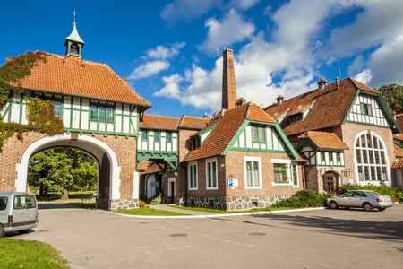 View on old Farm - Poland. Red brick wall and tiled roofs. Summer day.の写真素材