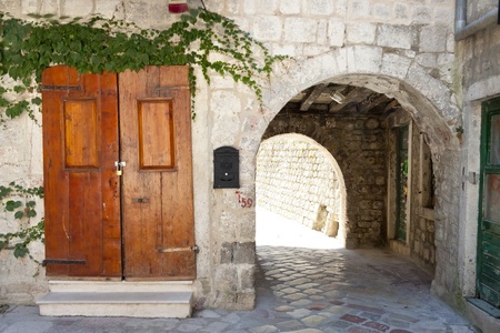 Wooden brown door and ole gate to fortification. Kotor - Montenegroの写真素材