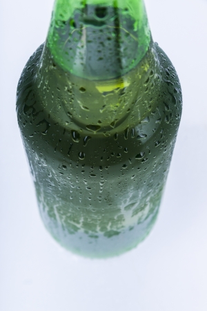 Wet bottle with cold beer on white background.の写真素材