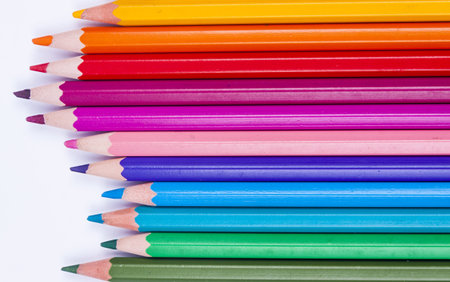 Pallet of colourful crayons on white background.