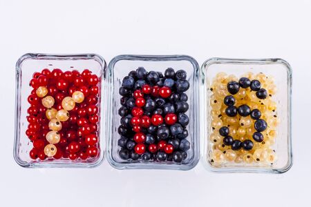 Blue berry, red and white currant on white background.の写真素材