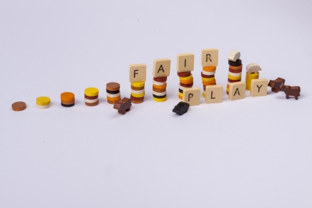 Fair play game - wooden column on white background の写真素材