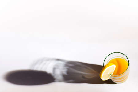 Fresh orange juice with lemon on white background.の写真素材