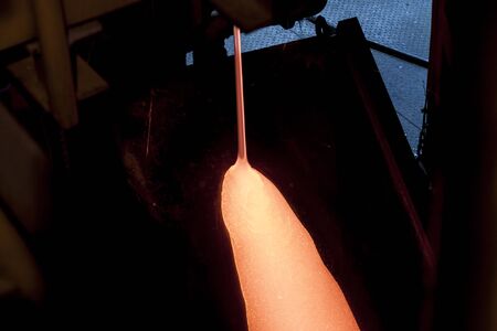 Liquid glass - production line in glassworksの写真素材