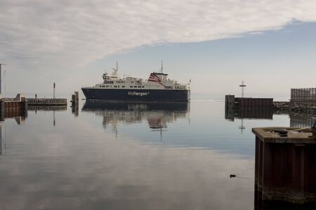 FYNSHAV, DENMARK - MAY 7, 2017: AlsFAERGEN ferry leaves port on may 7, 2017 in Fynshav, Denmark. The ferry connects Fynshav with Bojden in Denmark.のeditorial素材