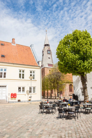 TONDER, DENMARK - MAY 7, 2017: People relaxing on sunny sunday in restaurant on main square of old...