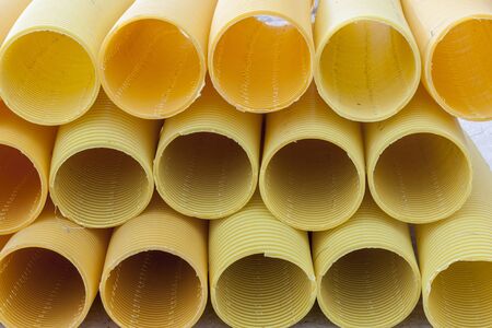 Yellow drain pipe - construction site.の写真素材