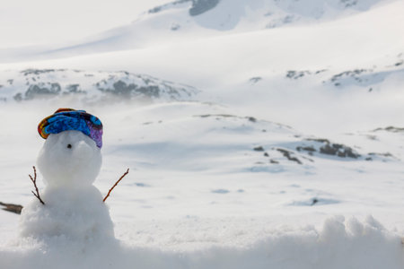 Little snowmen on highest pass in Norway.