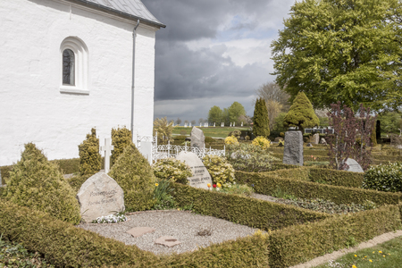JELLING, DENMARK - MAY 9, 2017:  White church on the monument area which enjoys UNESCO World Heritage patronage on may 9, 2017 in Jelling, Denmark.のeditorial素材