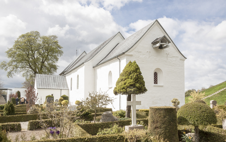 JELLING, DENMARK - MAY 9, 2017:  White church on the monument area which enjoys UNESCO World Heritage patronage on may 9, 2017 in Jelling, Denmark.のeditorial素材