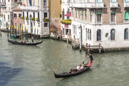 VENICE, ITALY -  MAY 2, 2019: Tourists visiting the old city of Venice on May 2,2019 in Venice in Italy. View on Grand Canal in Venice.のeditorial素材
