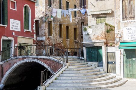 Narrow canal in old town of Venice in Italyの写真素材