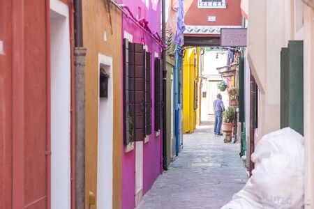Tourist on street of old Colorful city of Buranoの写真素材
