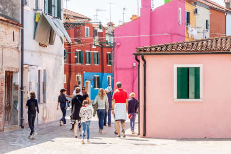 Burano, ITALY -  MAY 2, 2019: Tourist on street of old Colorful city of Burano on May 2,2019 in Burano island in Italy. View on Colorful houses.のeditorial素材