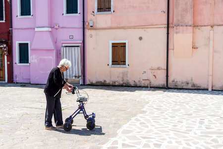 Burano, ITALY -  MAY 2, 2019: Tourist on street of old Colorful city of Burano on May 2,2019 in Burano island in Italy. View on Colorful houses.のeditorial素材
