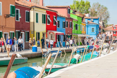 Burano, ITALY -  MAY 2, 2019: Tourist on street of old Colorful city of Burano on May 2,2019 in Burano island in Italy. View on Colorful houses.のeditorial素材