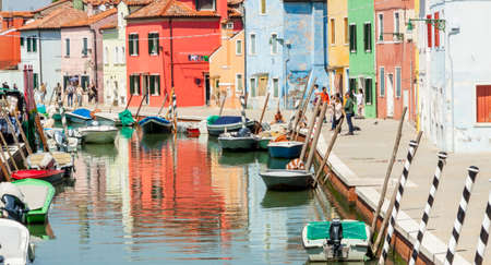 Burano, ITALY -  MAY 2, 2019: Tourists visiting the old Colorful city of Burano on May 2,2019 in Burano island in Italy. View on Colorful houses.のeditorial素材