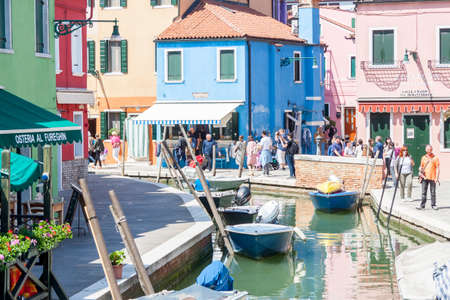Burano, ITALY -  MAY 2, 2019: Tourist on street of old Colorful city of Burano on May 2,2019 in Burano island in Italy. View on Colorful houses.のeditorial素材