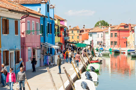 Burano, ITALY -  MAY 2, 2019: Tourists visiting the old Colorful city of Burano on May 2,2019 in Burano island in Italy. View on Colorful houses.のeditorial素材