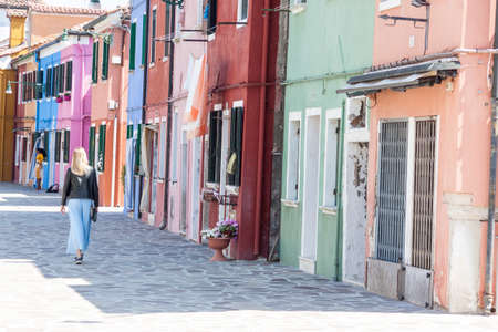 Burano, ITALY -  MAY 2, 2019: Tourist on street of old Colorful city of Burano on May 2,2019 in Burano island in Italy. View on Colorful houses.のeditorial素材