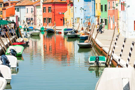 Burano, ITALY -  MAY 2, 2019: Tourists visiting the old Colorful city of Burano on May 2,2019 in Burano island in Italy. View on Colorful houses.のeditorial素材