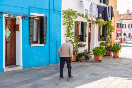 Burano, ITALY -  MAY 2, 2019: Tourist on street of old Colorful city of Burano on May 2,2019 in Burano island in Italy. View on Colorful houses.のeditorial素材