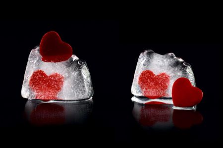 Four hearts in melting icecubes with medium reflection on black backgroundの写真素材