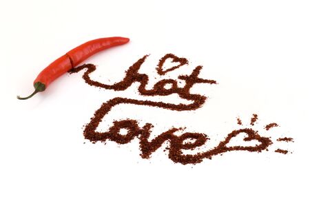 Hot chili pepper love at  white isolated white background with focus on loveの写真素材