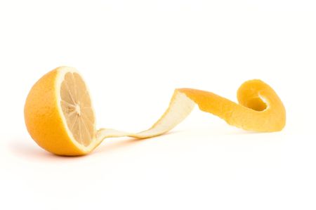 Fresh lemon with cut long peel on isolated white background, focus at center of the lemonの写真素材